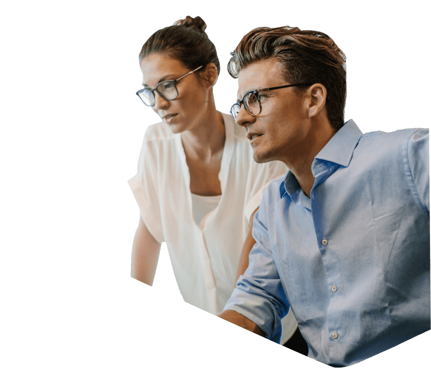 A man and woman wearing glasses looking at a screen together