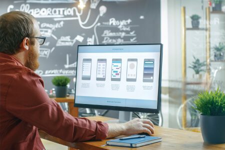 It engineer male working with desktop from office on Application Development Process layout for mobile