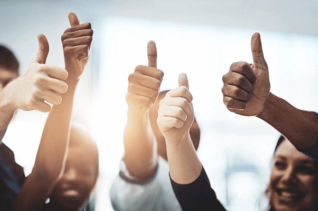 group of employees showing thumbs up symbol