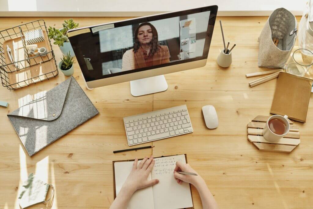 employee managing working remotely by video call with female team leader