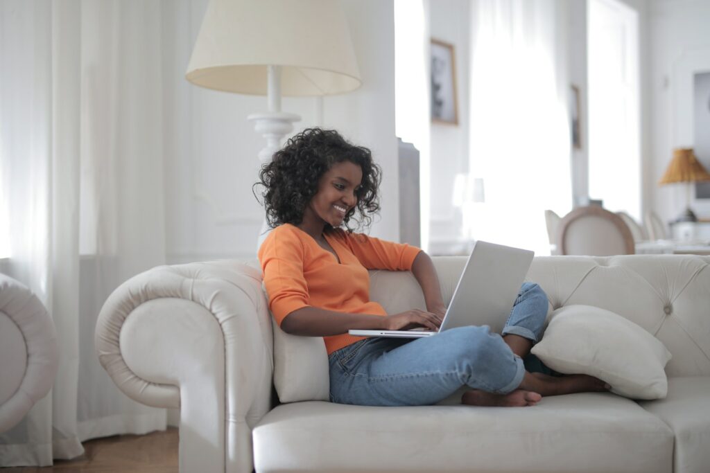 Young female employee working remotely with laptop