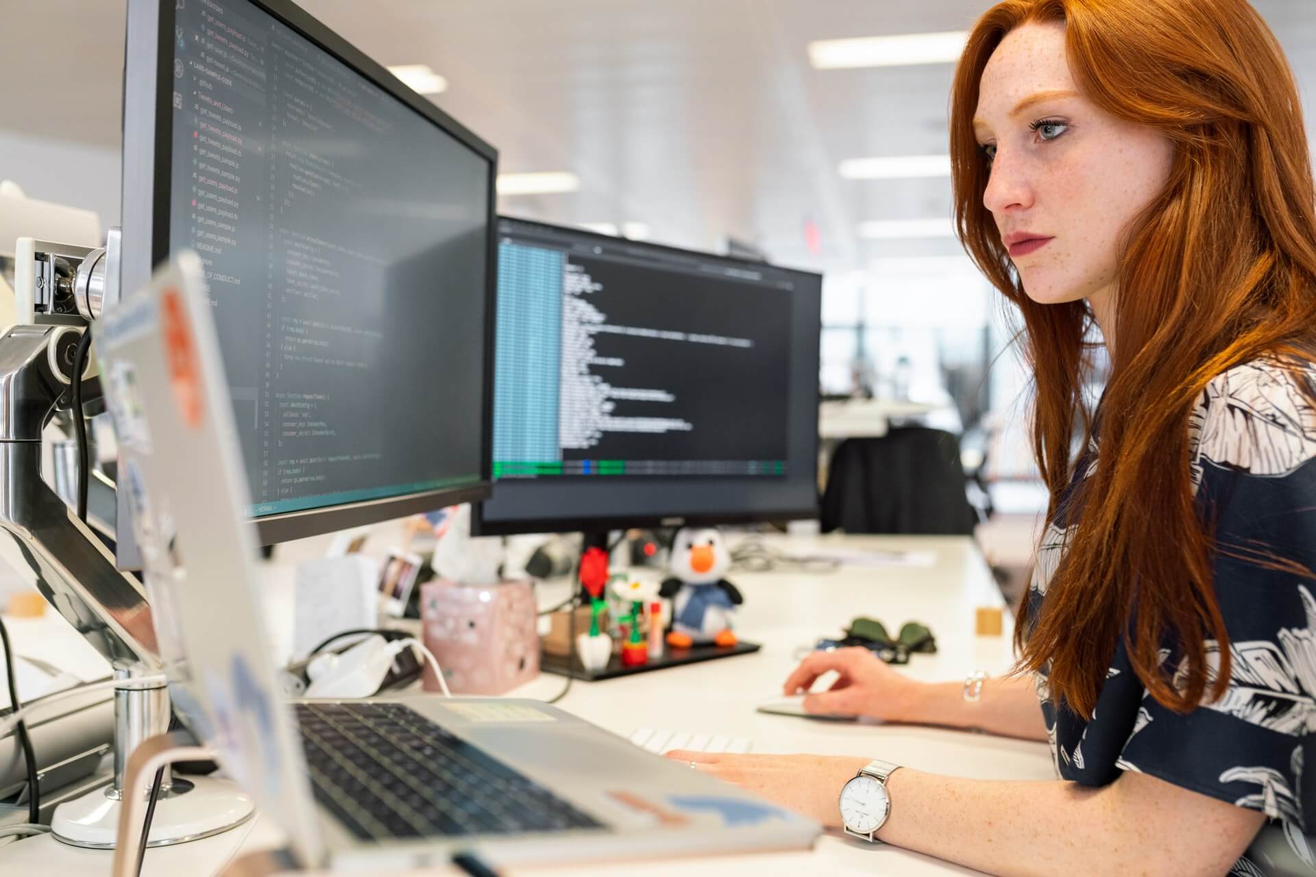 woman working on computer low code development platform