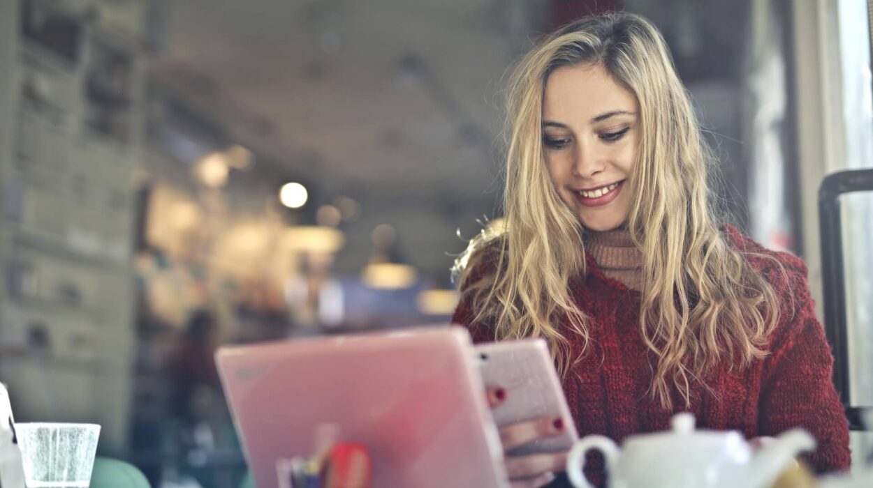 woman smiling while using mobile phone