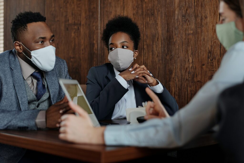 Business people in mask talking to each other