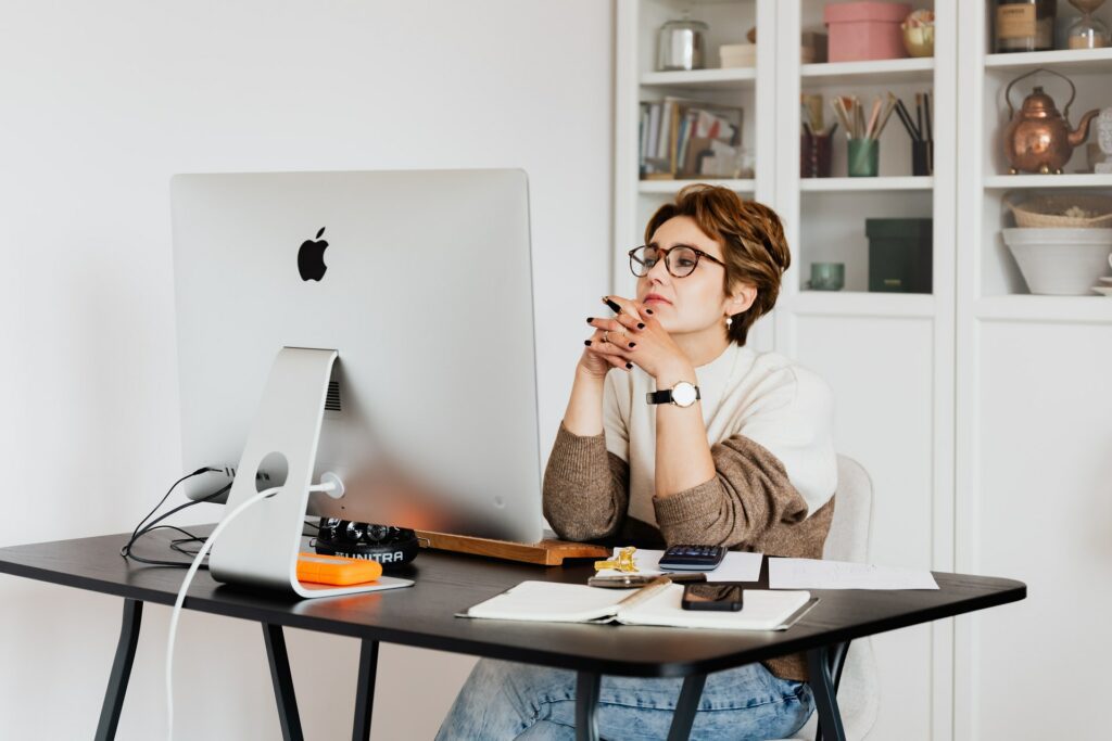 A woman looking at the big screen monitor in modern workplace shows future of work