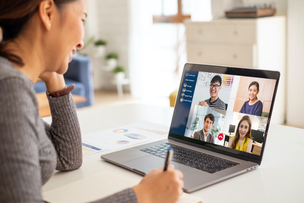 Young female employee working virtually collaborated with other team members.