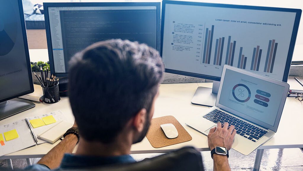 A person working on laptop looking at modern analytics data