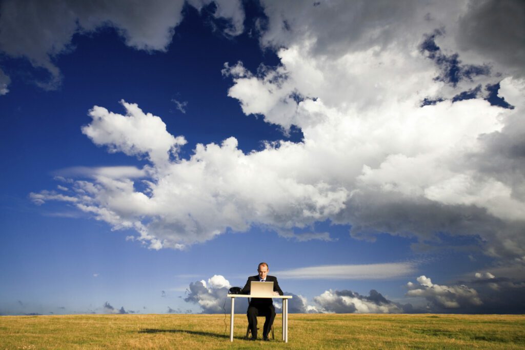 cloud engineer working with laptop from outdoor on optimizing cloud costs