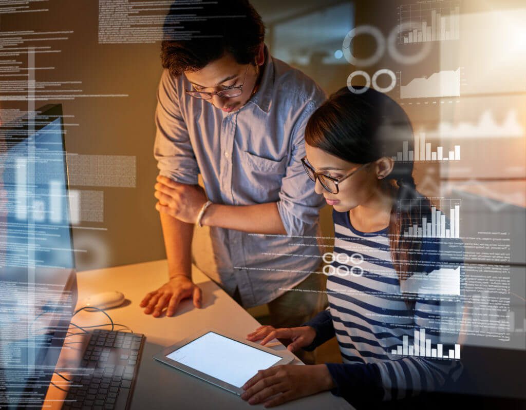 Young male and female IT engineers analysing reports.