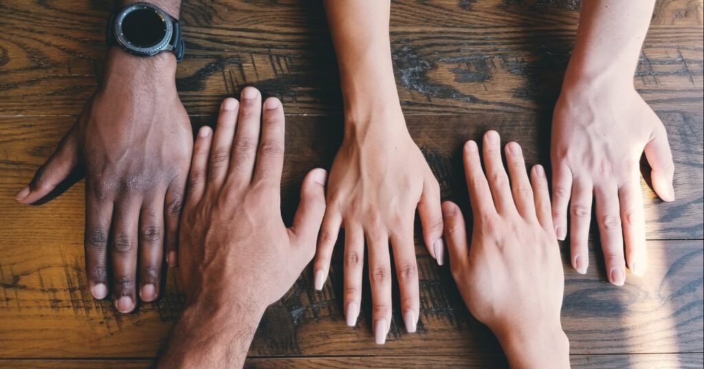 different employees hands on table