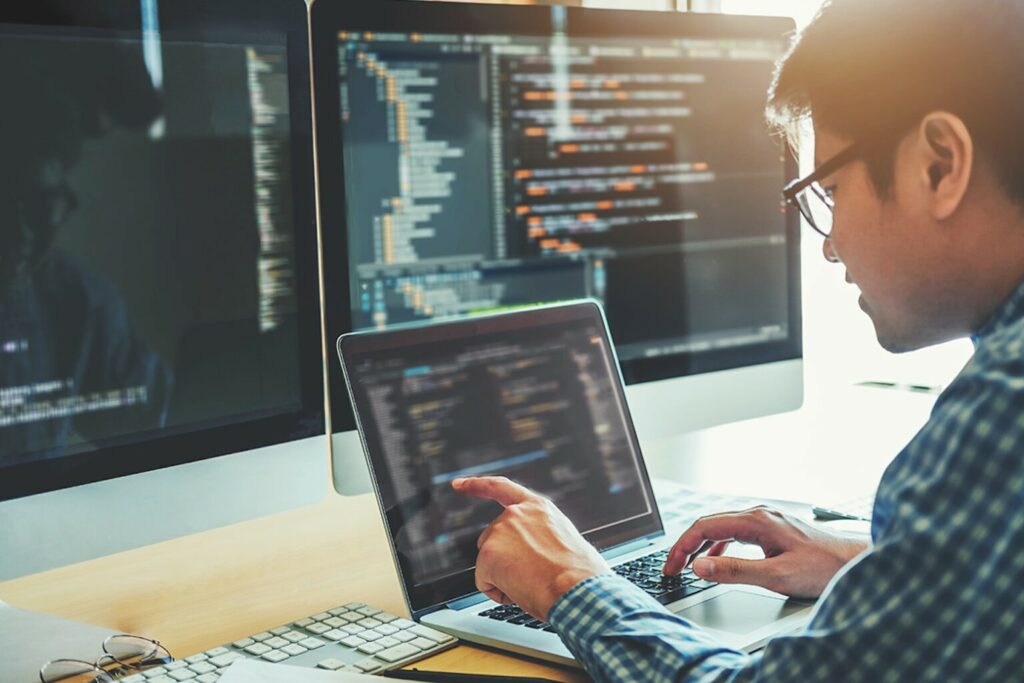 man showing coding on his laptop