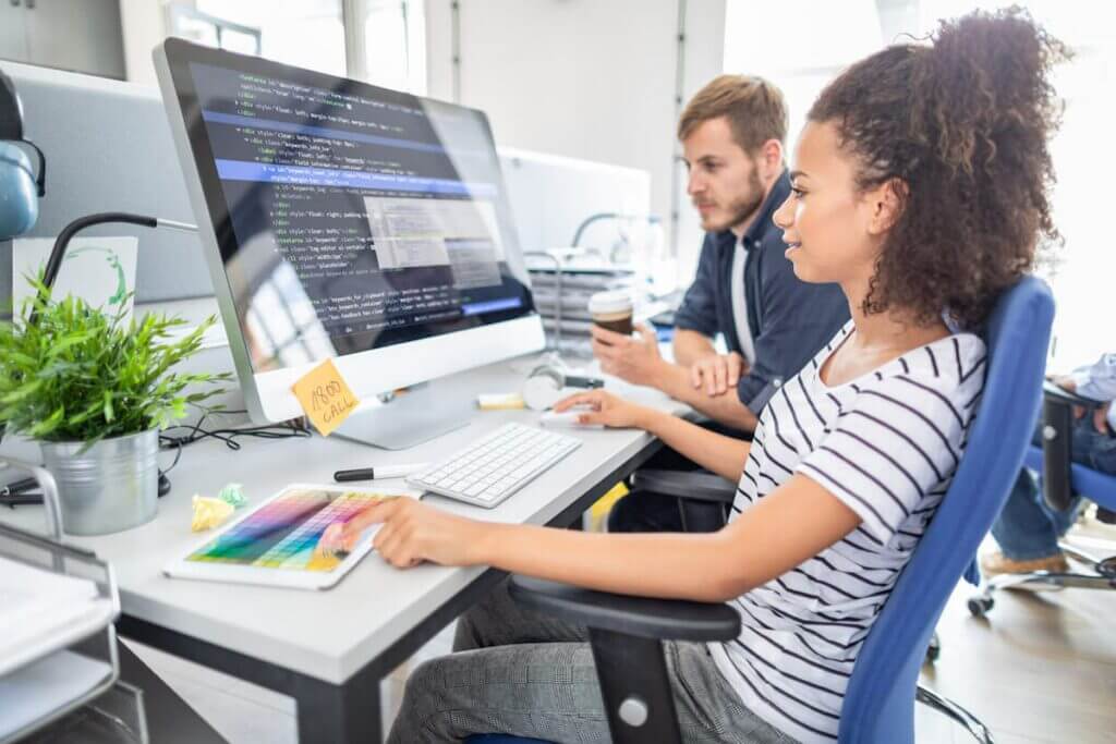 Young female and male IT employees working on Cloud computing programming.