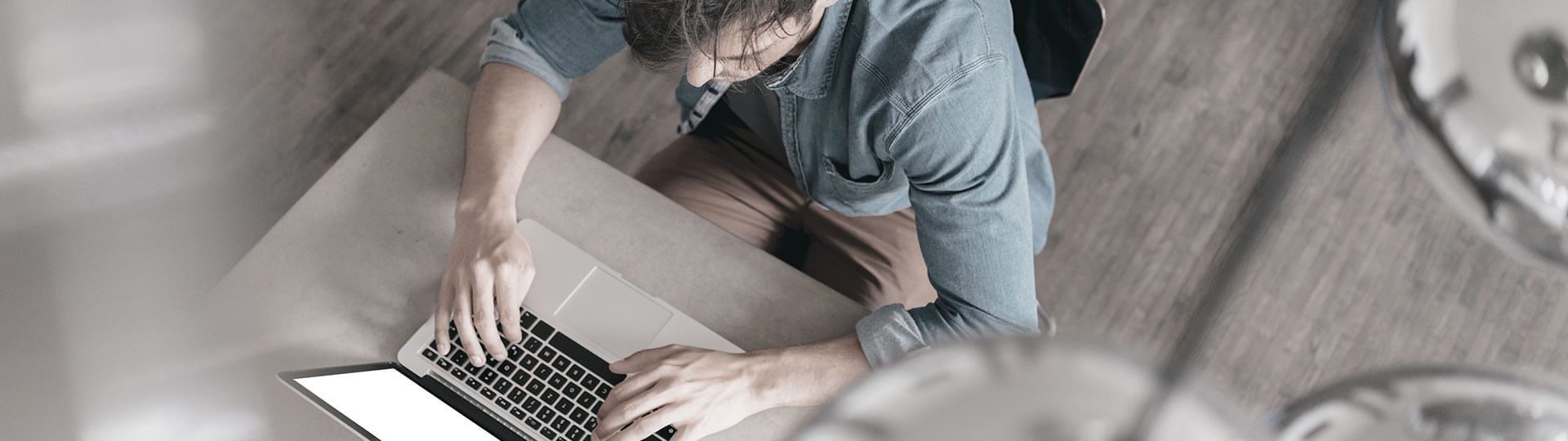 Top view of IT engineer working with laptop on desk.