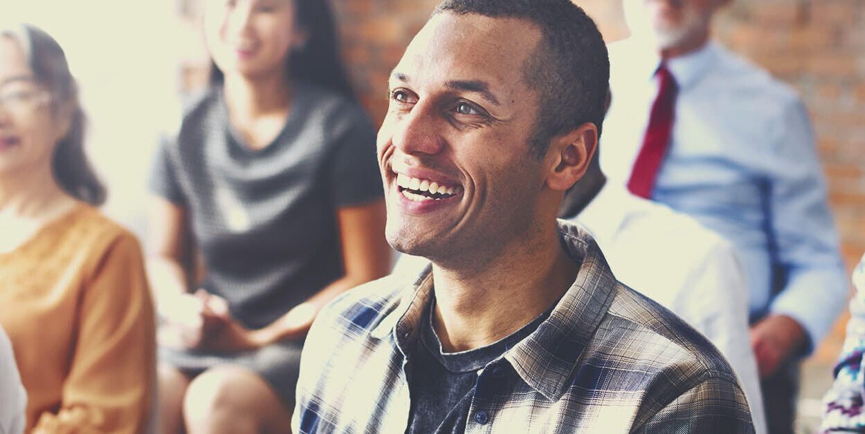 a man smiling after successfully implementing business innovation
