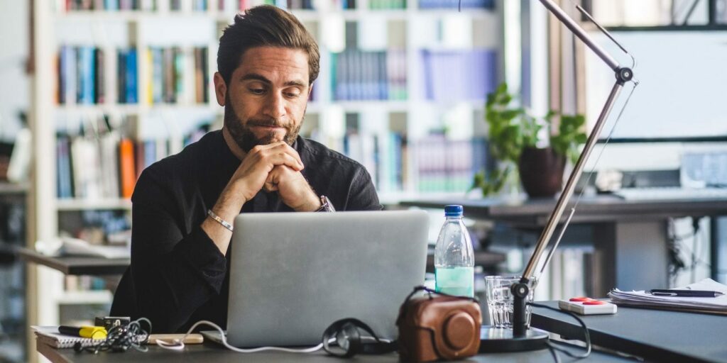 IT employee working on SAML authentication process with laptop 