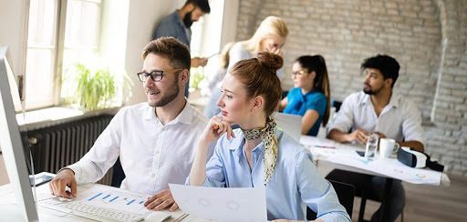 UX engineers analysing reports from desktop screen