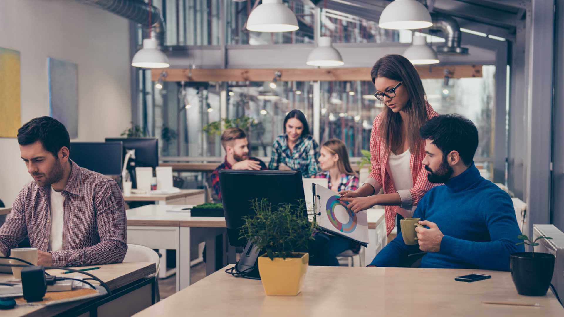 Young woman showing diagram of AI work productivity growth to her colleague.