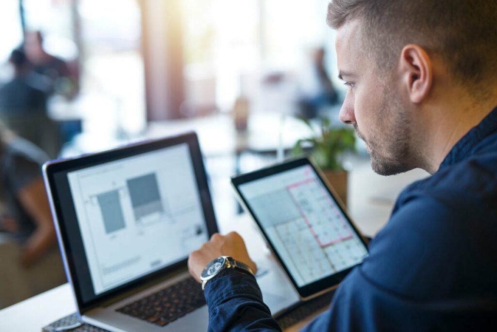 IT engineer working on Microsoft Cloud application with laptop