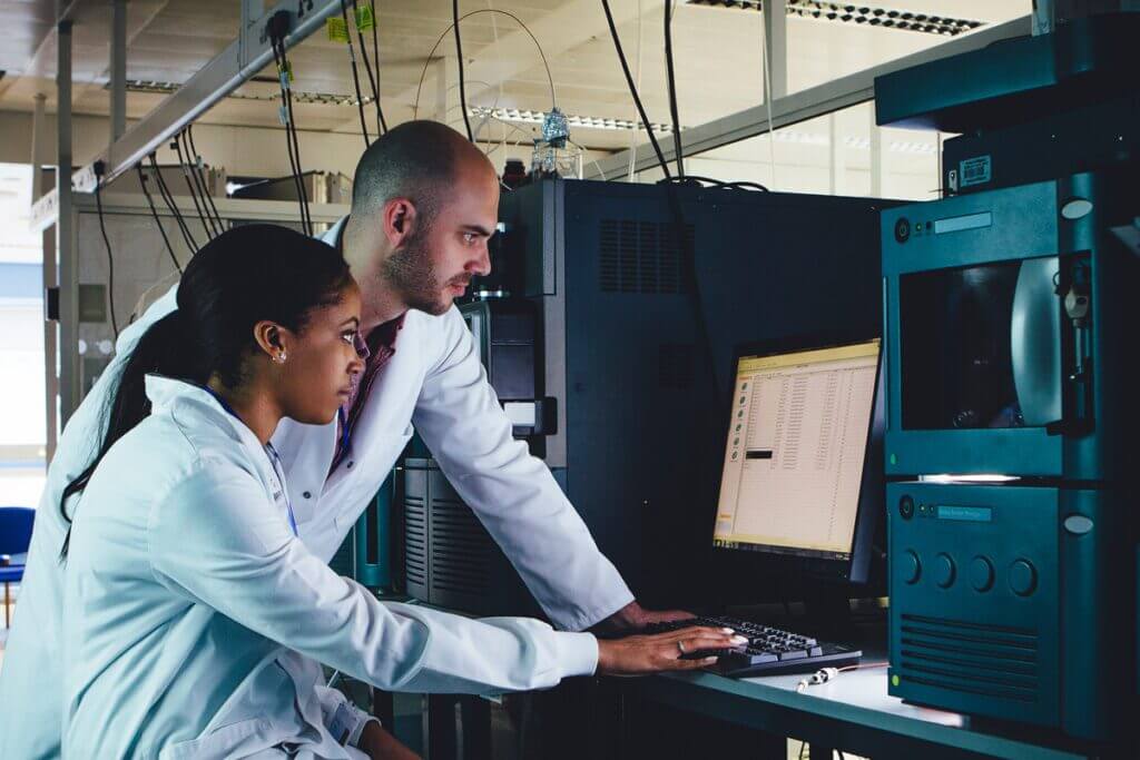 Health care employees working on security files with desktop.