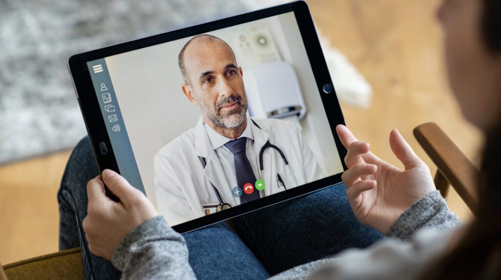 a digital patient engagement doing video call through ipad and talking to the doctor
