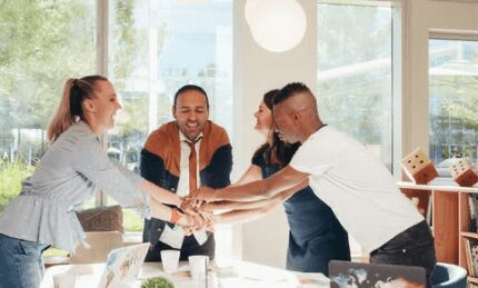 men and women shaking hands at work place