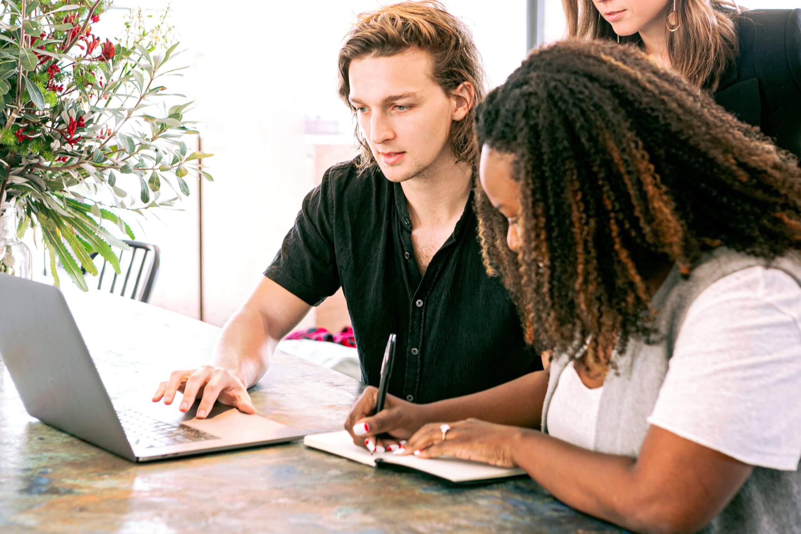 Man showing his laptop screen to colleagues about automation software