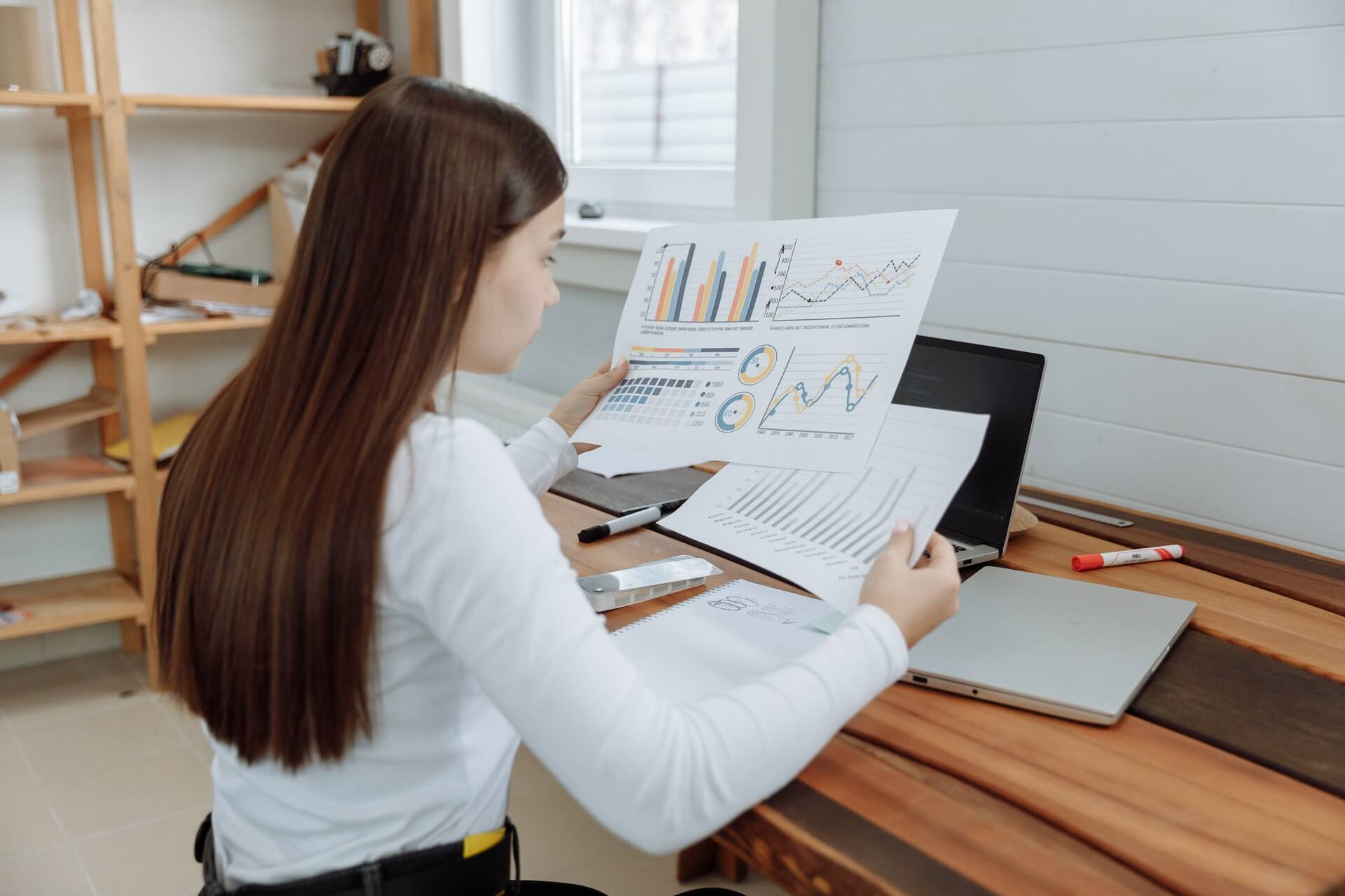 woman looking at graph charts for insights on RPA
