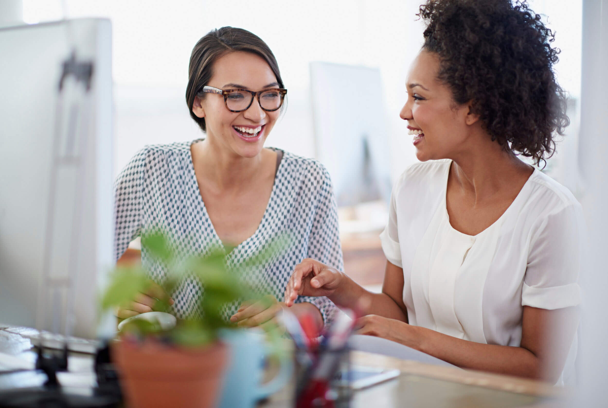 two women talking to each other about website design