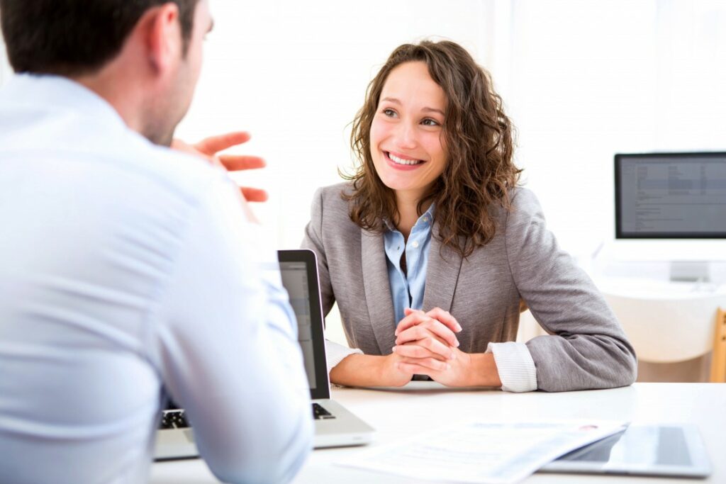 A man taking interview of a woman for IT hiring