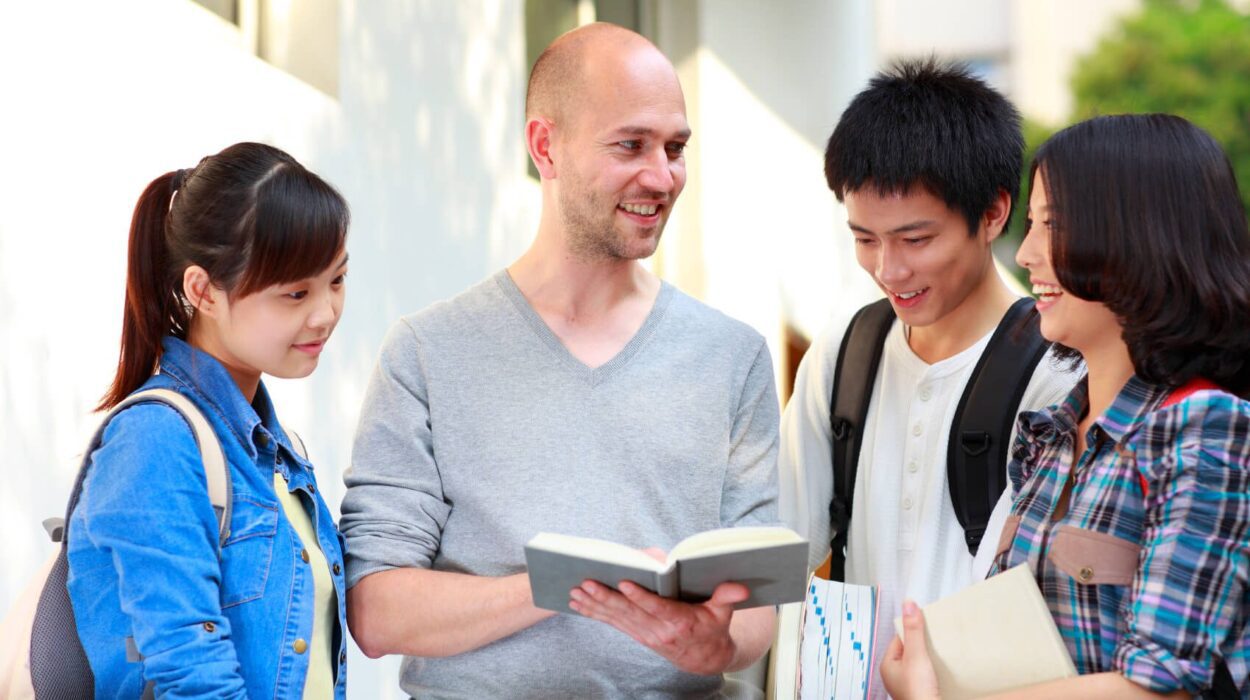 Four STEM graduates talking to each other. They have notebooks in their hands