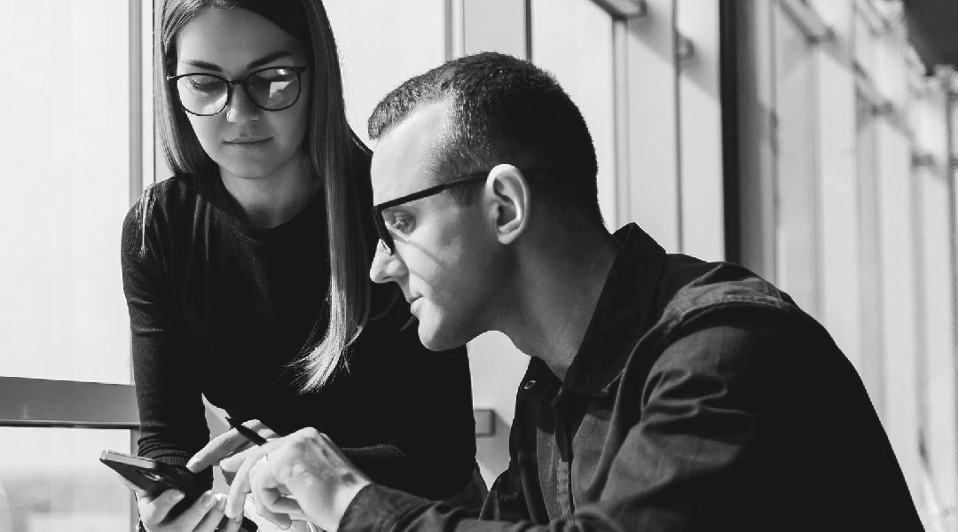 a man and a woman discussing benefits of iPaaS