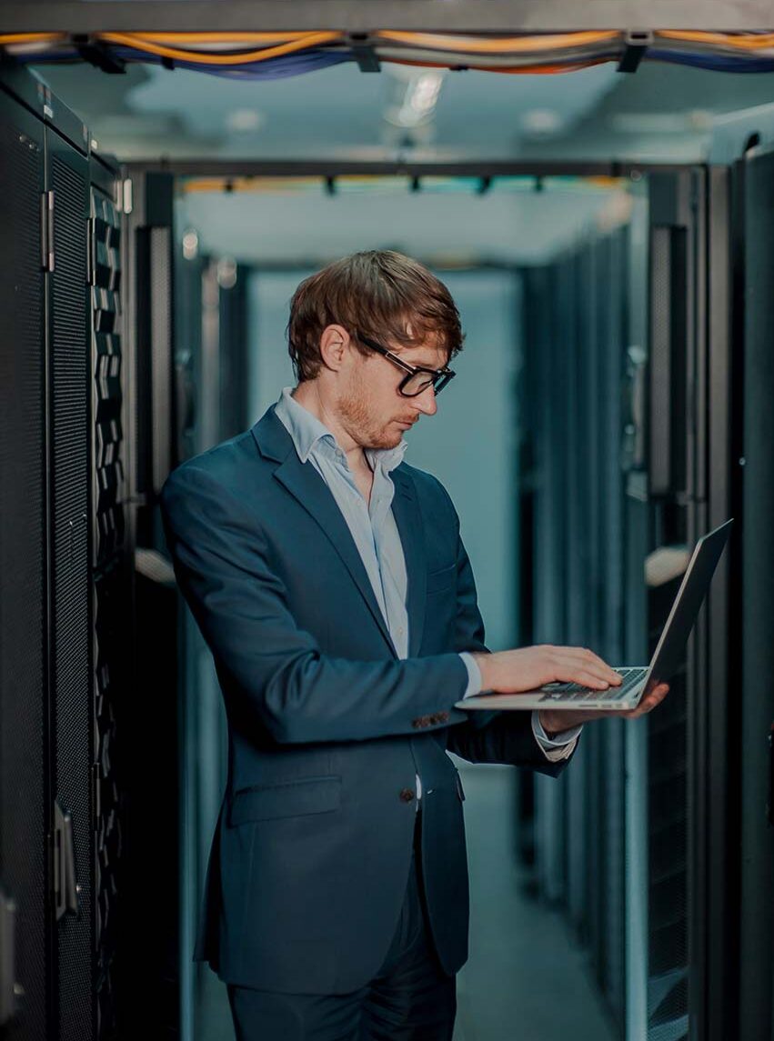 man reviewing automated processes in server room