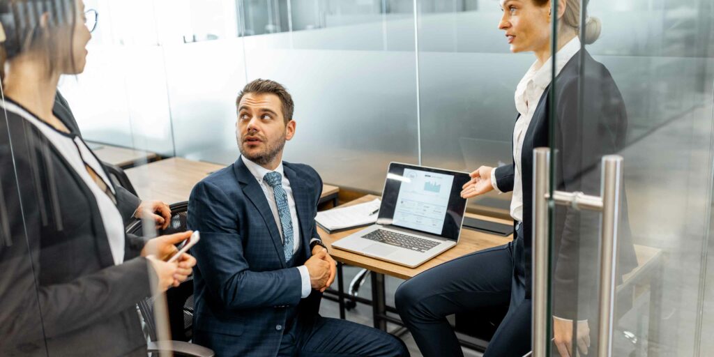 three banking professionals talking about IT GRC in banking