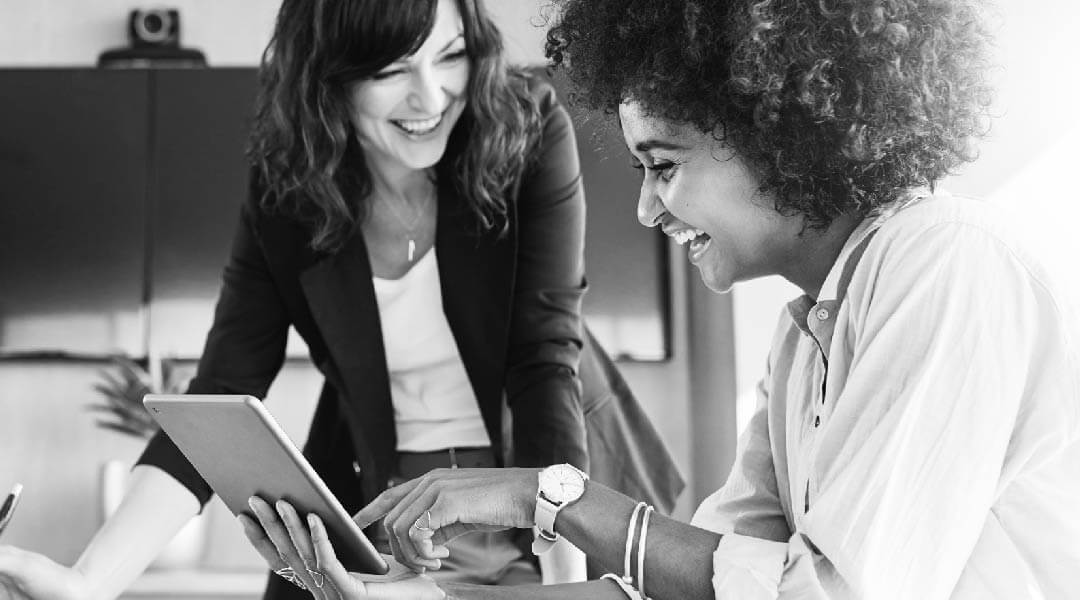 women discussing digital content on ipad