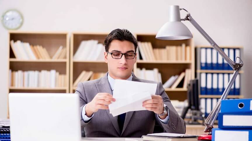 A man looking at EB2 premium processing document