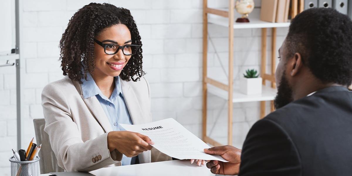 A woman TN visa lawyer giving papers to an employee