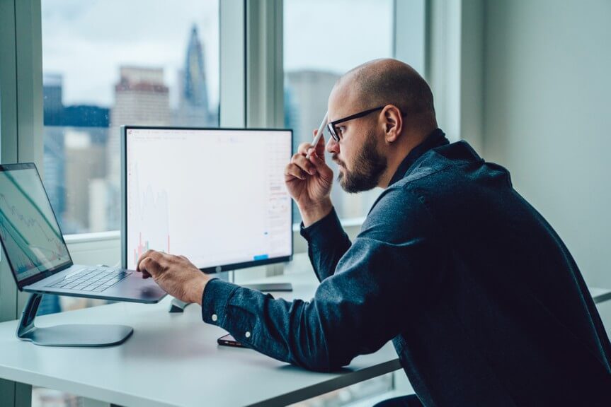 A man working on the laptop and searching for TN visa information 