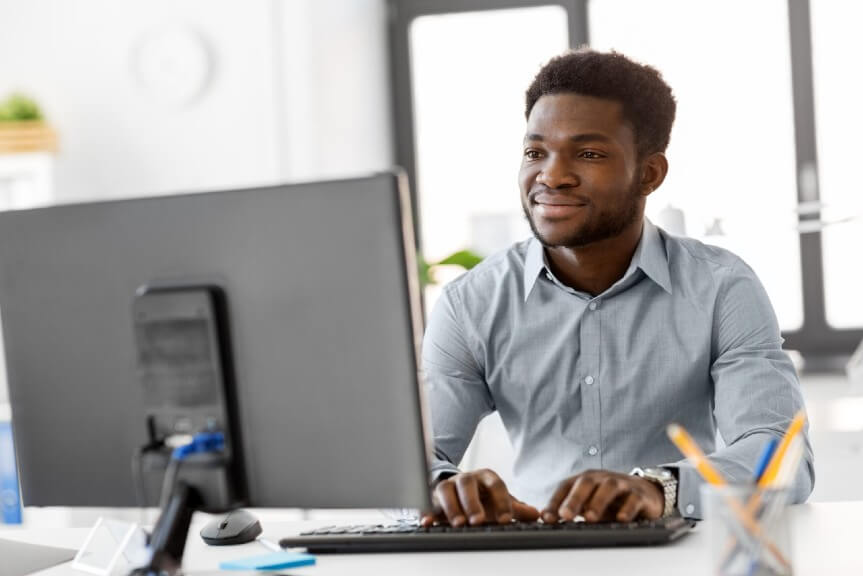 A man working on the green card application on the computer