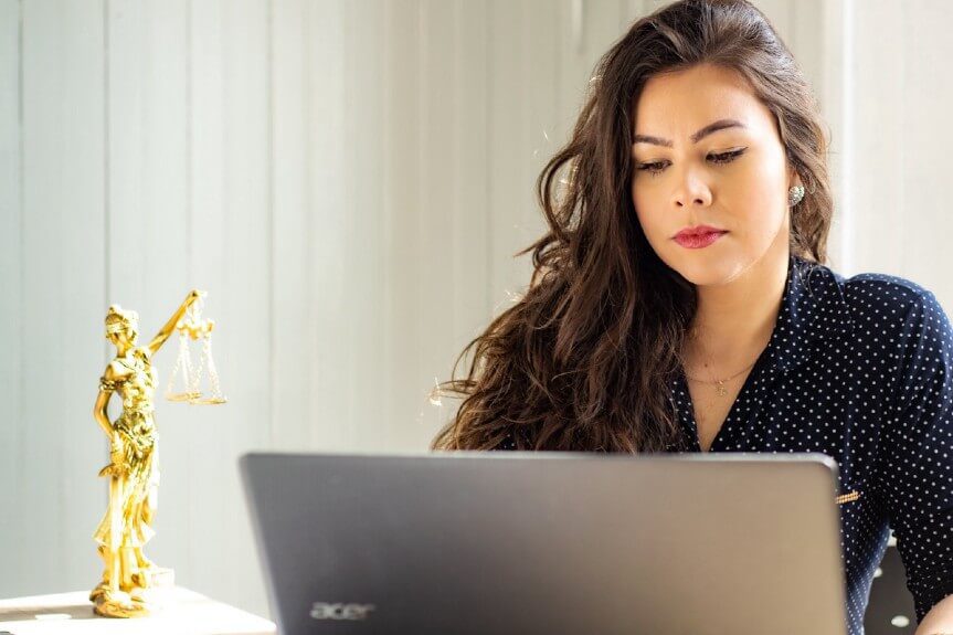 an immigration lawyer working on the laptop