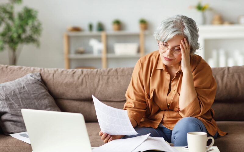 Stressed Women looking at open enrollment reports. 