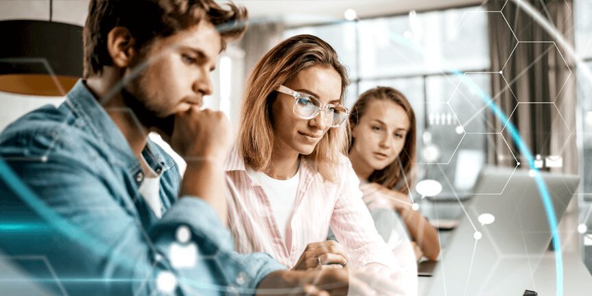 One Young Male and Two Female IT Employees Looking at Laptop Screen