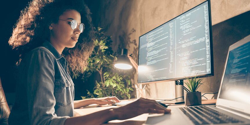 Young Female IT Engineering Working on Code using Desktop