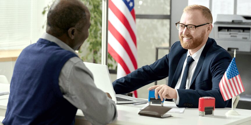 Happy employee getting approval on concurrent H-1B visa in an interview with USCIS officer.